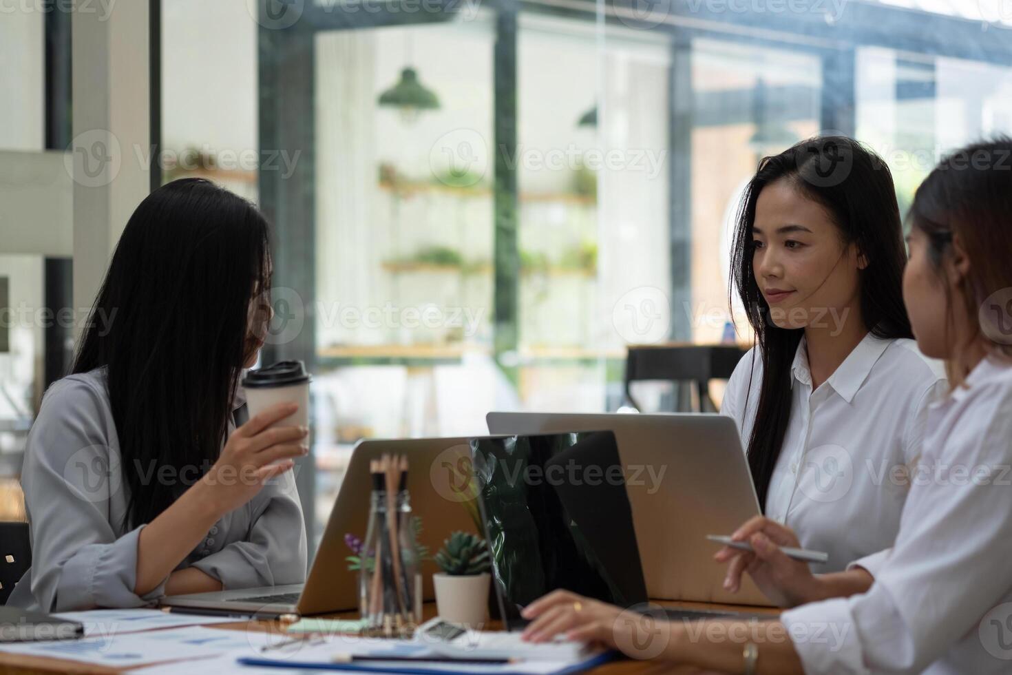 Business asian team collaboration discussing working analyzing with financial data and marketing growth report graph in team, presentation and brainstorming to strategy planning making profit photo