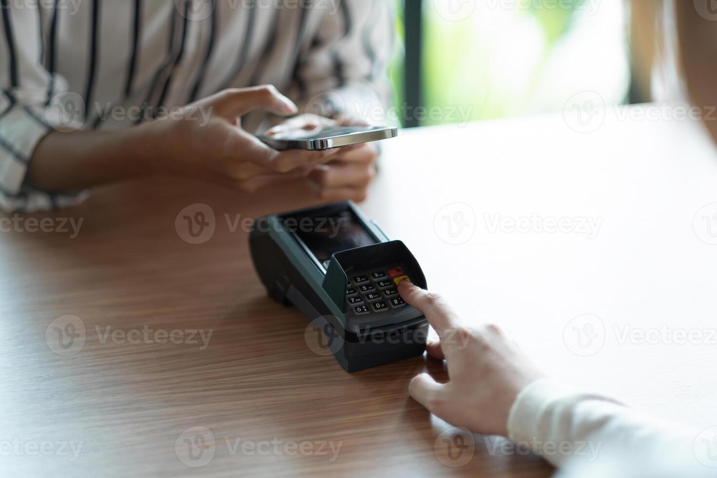 Close up customer make mobile payment contactless paying with NFC technology on smart phone. photo