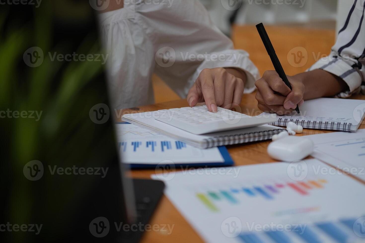 Close up Businessman and partner using calculator and laptop for calaulating finance, tax, accounting, statistics and analytic research concept. photo