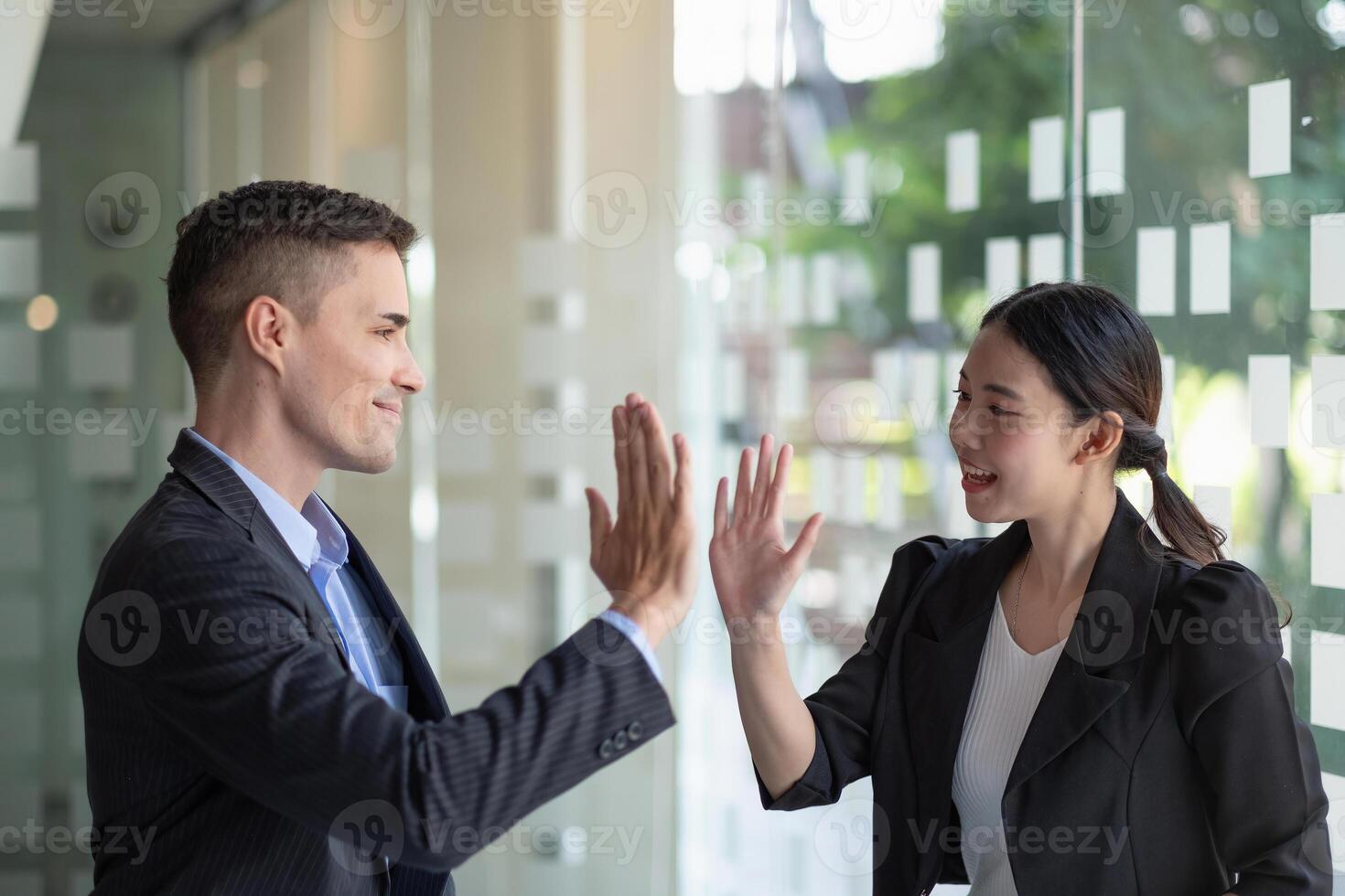 Business man and woman business hi five bump hand together for team work, diversity caucasian asd asian business team concept. photo