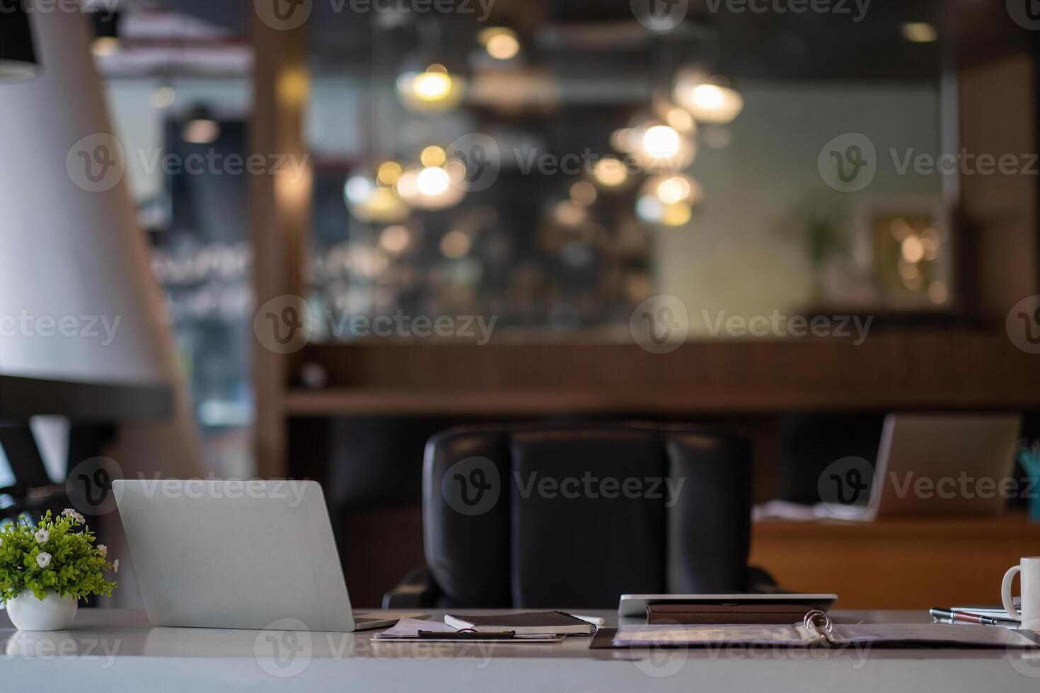 Working Place on white table with Laptop Computer green plants and paperwork in modern office interior photo