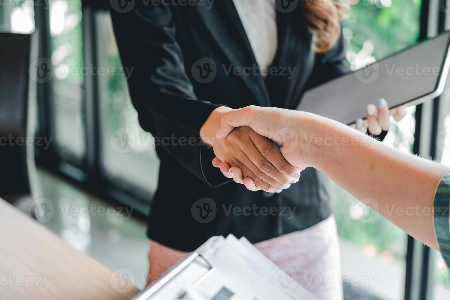 two businessman shake hands as hello in office closeup. Friend welcome, introduction, greet or thanks gesture, product advertisement, partnership approval, strike a bargain on deal concept photo