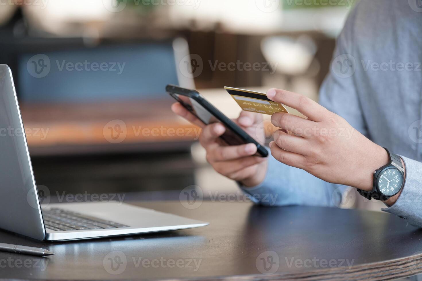 Online payment, Close up man's hands holding smartphone and using credit card for online shopping photo