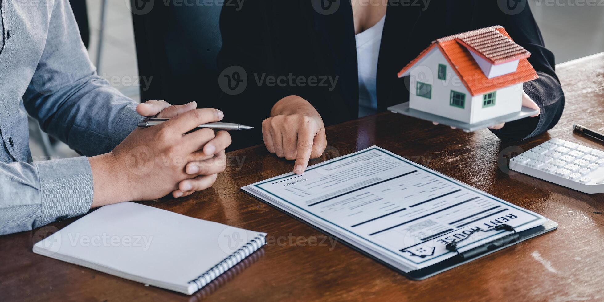Real estate agent talked about the terms of the home purchase agreement, customer sign the documents to make the contract legally, Home sales and home insurance concept photo