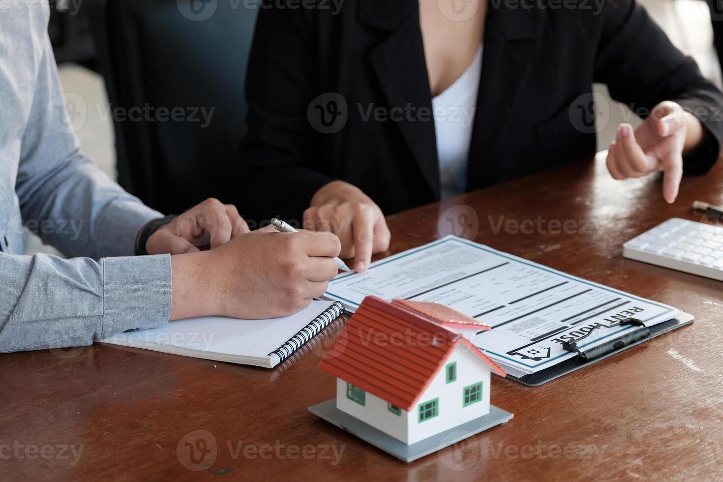 Real estate agent talked about the terms of the home purchase agreement, customer sign the documents to make the contract legally, Home sales and home insurance concept photo