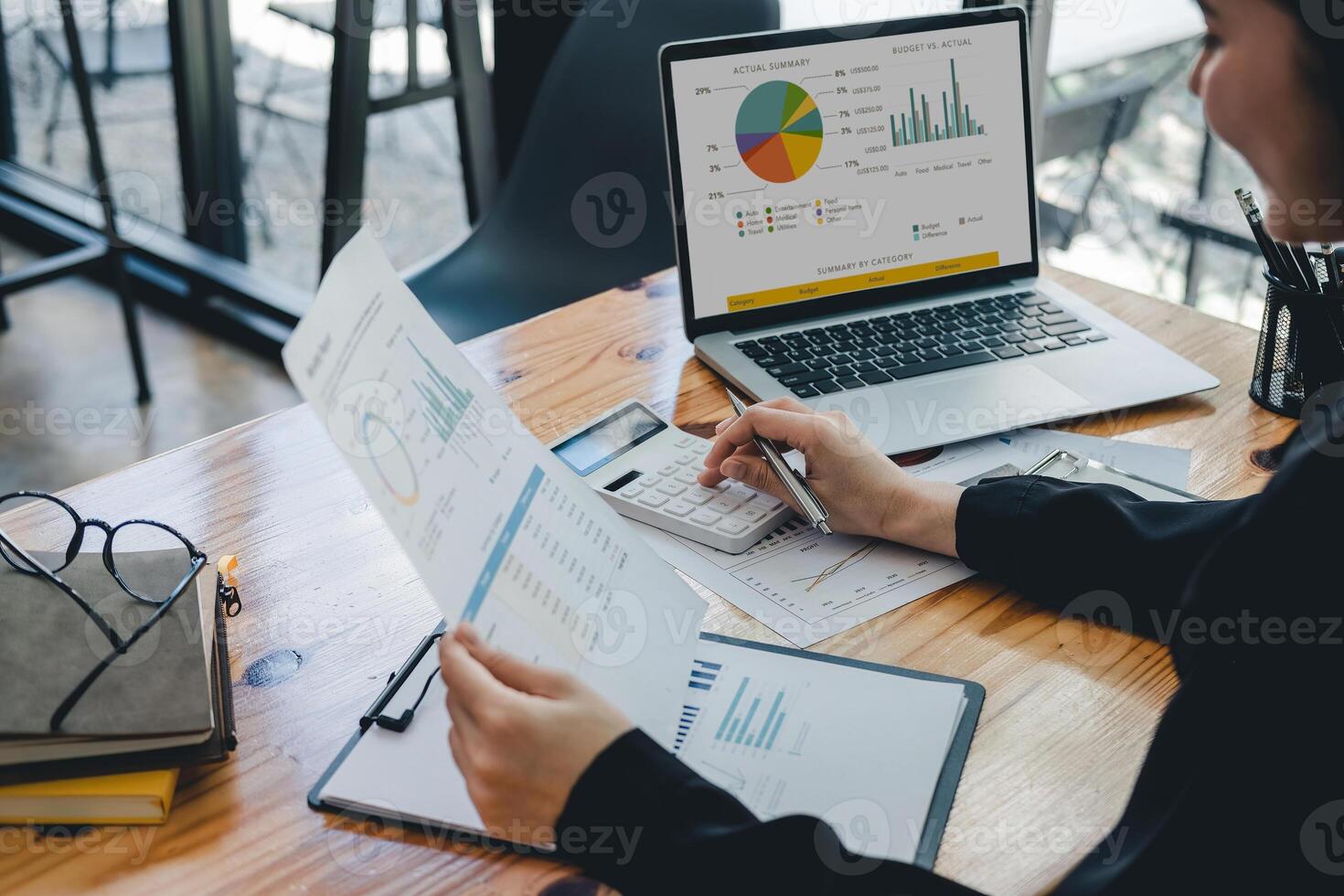 Business woman using calculator for analysis maketing plan, Accountant calculate financial report, computer with graph chart. Business, Finance and Accounting concept photo