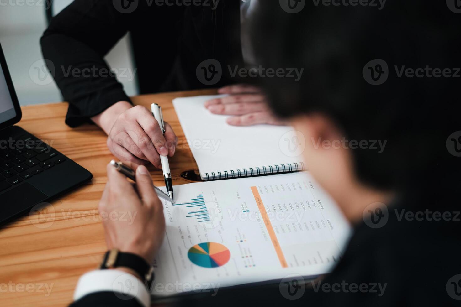 Diverse businesspeople discuss financial report in charts diagrams and graphs close up, business partners analysing common sales statistics presenting deal benefits at group meeting concept photo