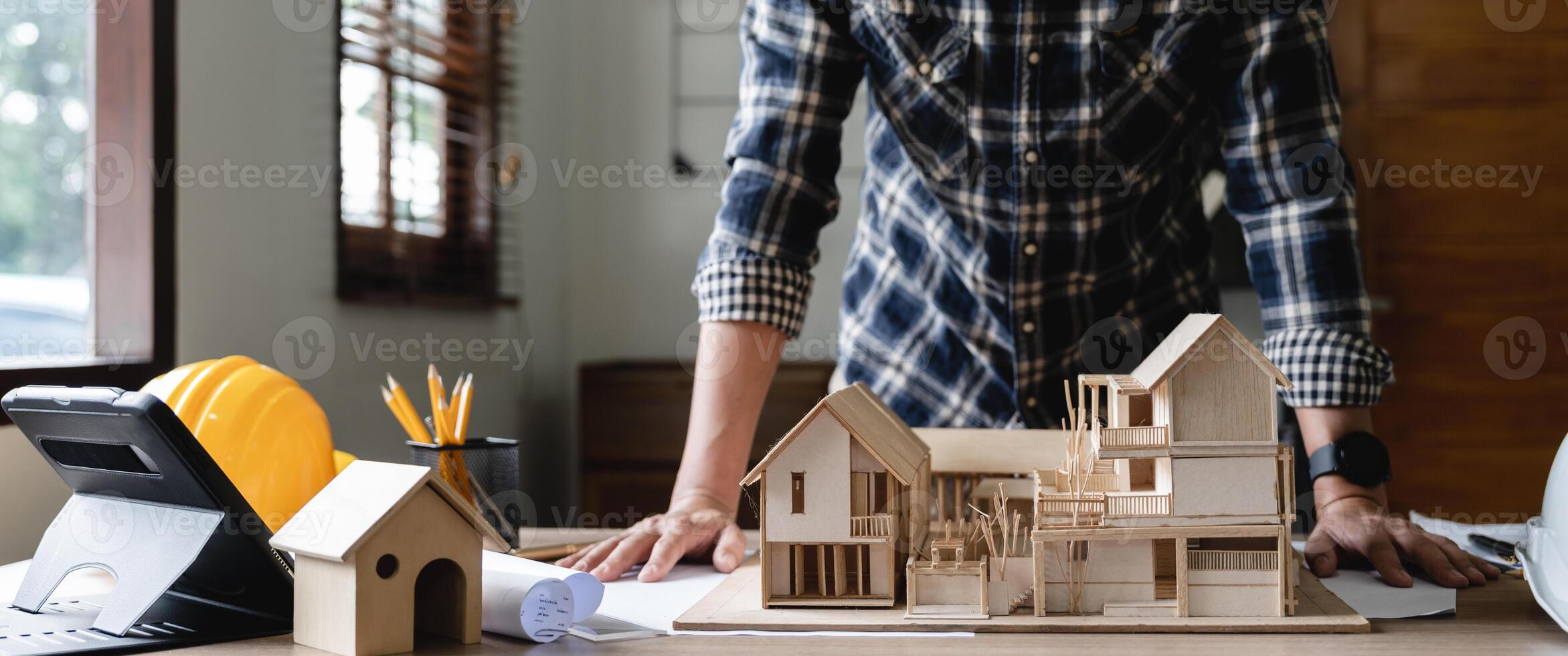 Engineer architect designer freelance work on start-up project with home model, construction plan. architect design working drawing sketch plans blueprints and making construction model. Architects photo