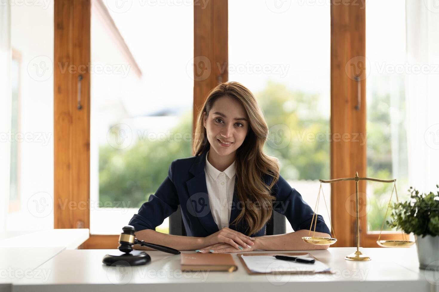 Business woman and lawyers discussing contract papers with brass scale on wooden desk in office. Law, legal services, advice, Justice and real estate concept. photo