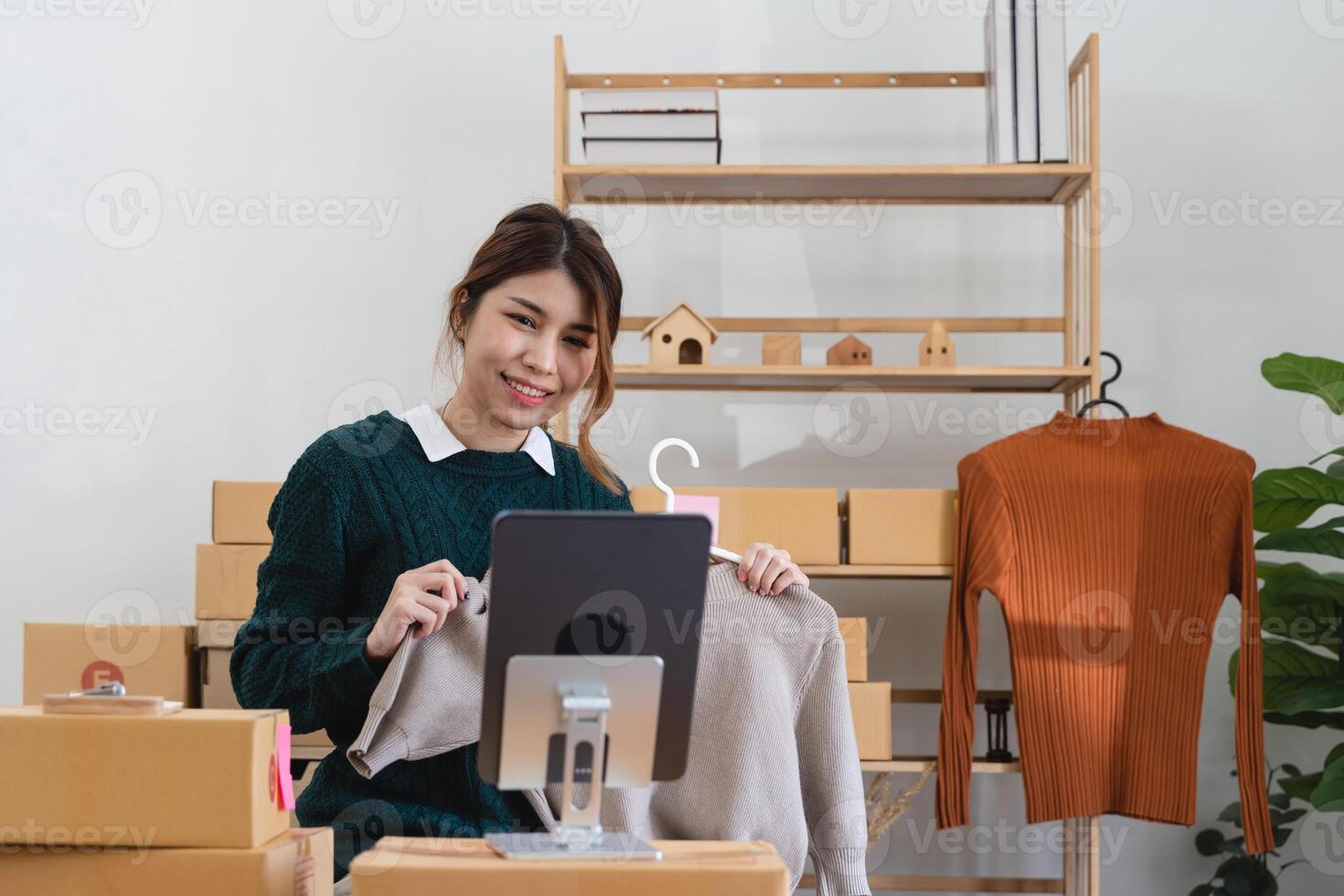 Asian woman freelancer sme business online shopping working with parcel box at home - SME business online and delivery concept photo