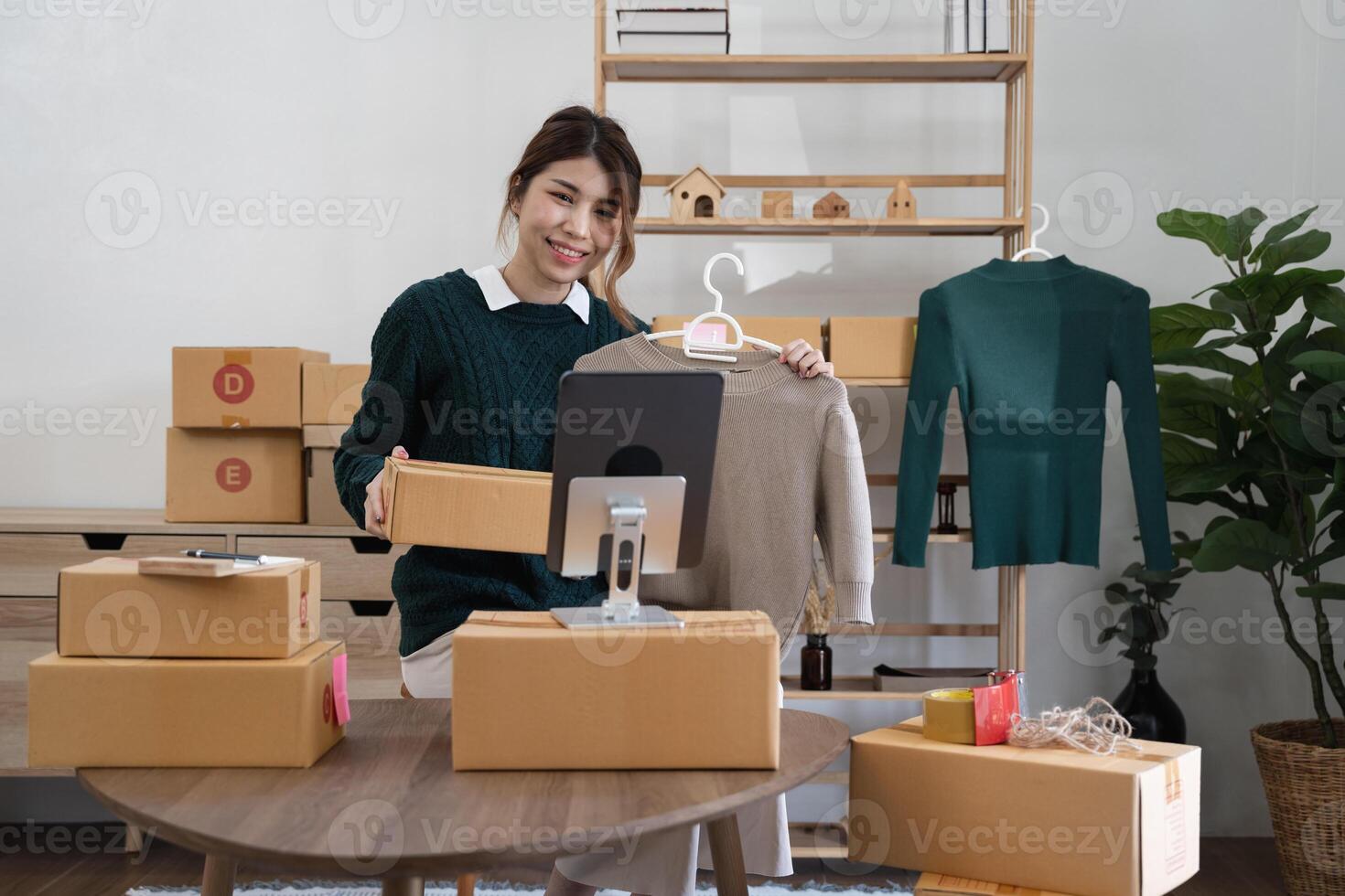 Asian woman freelancer sme business online shopping working with parcel box at home - SME business online and delivery concept photo