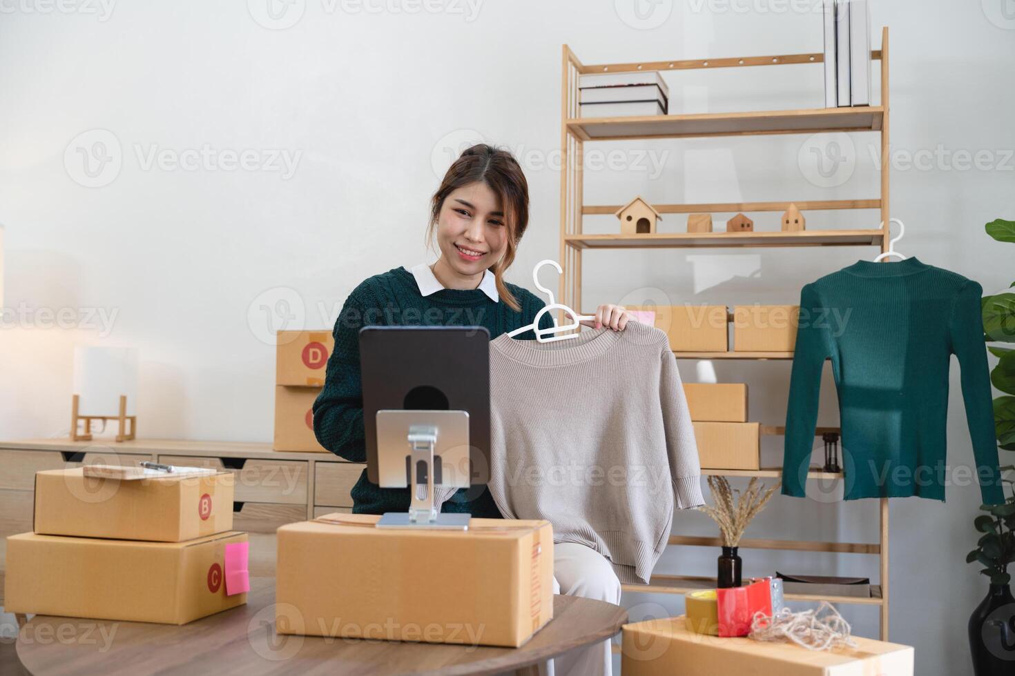 Asian woman freelancer sme business online shopping working with parcel box at home - SME business online and delivery concept photo