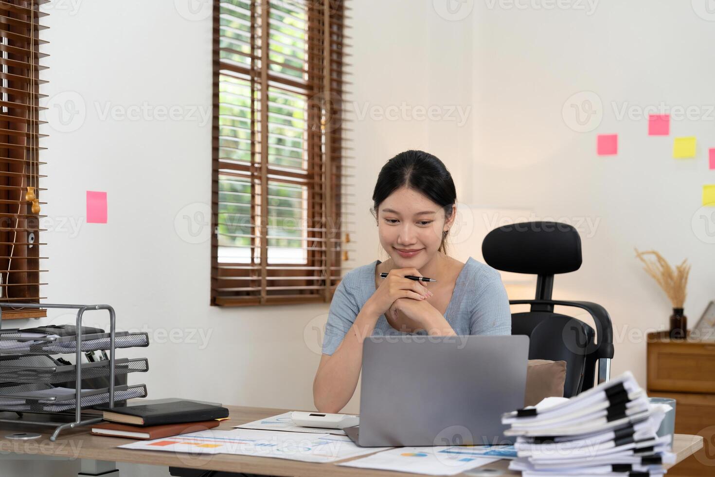 Portrait accounting asian woman working for financial with paperwork using laptop computer. photo