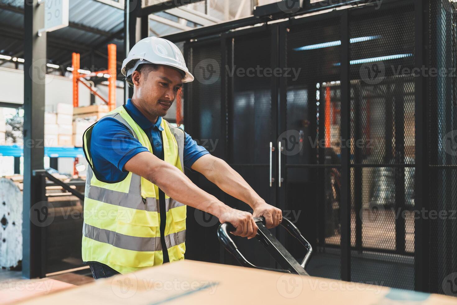 Asian male warehouse staff worker manage factory products goods and shipping to customer. photo