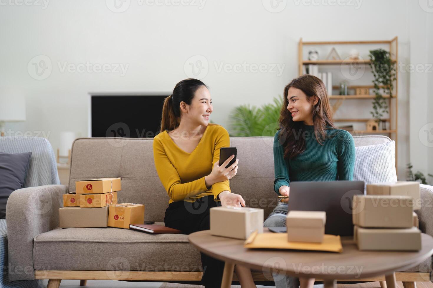 Two women busines startup for online marketing, Entrepreneur packing boxes parcels for shipping, SME sellers, and freelance online sales concept photo