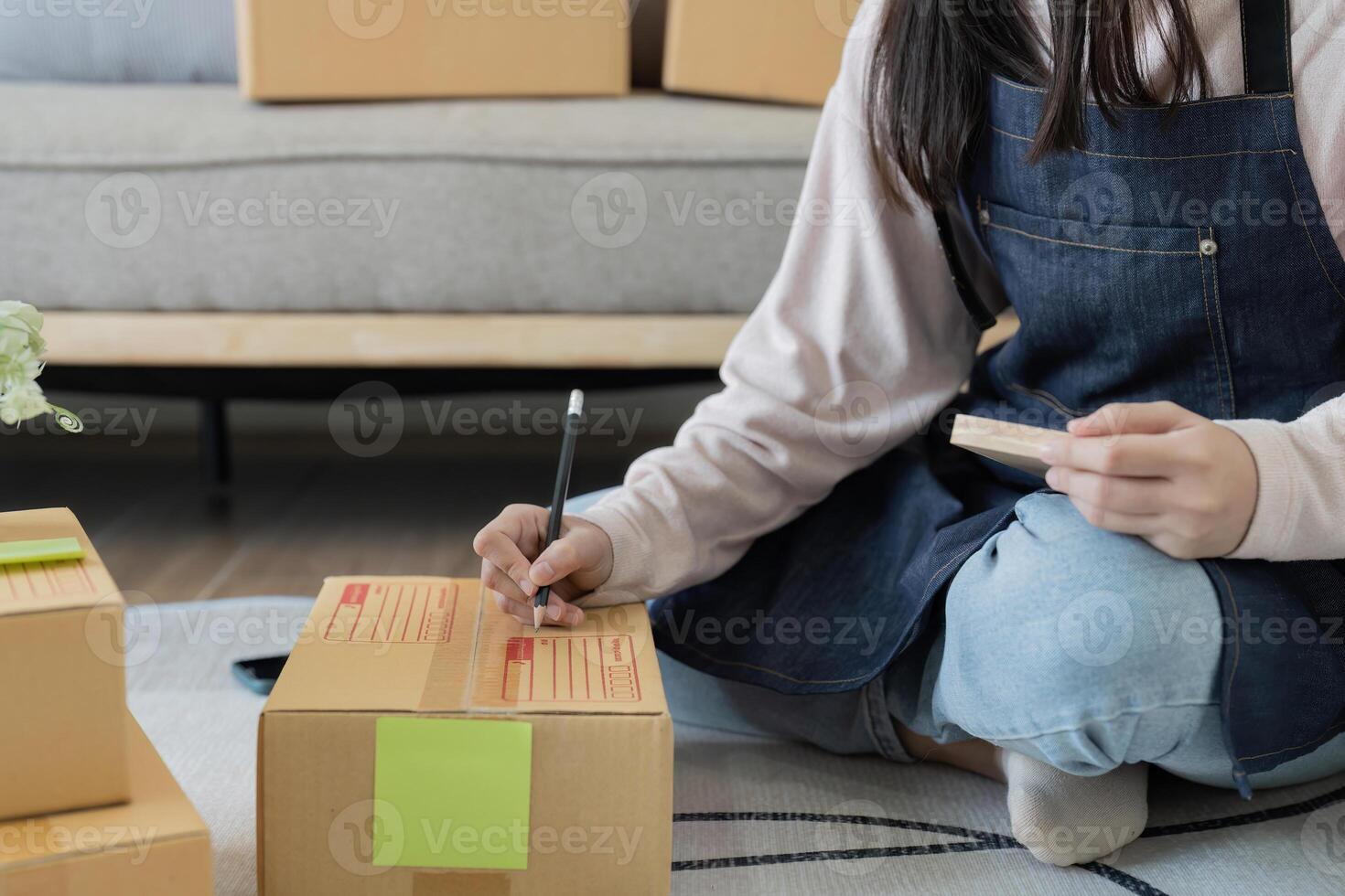 Starting small businesses SME owners woman entrepreneurs working, box and check online orders to prepare to pack the boxes, sell to customers, sme business ideas online photo