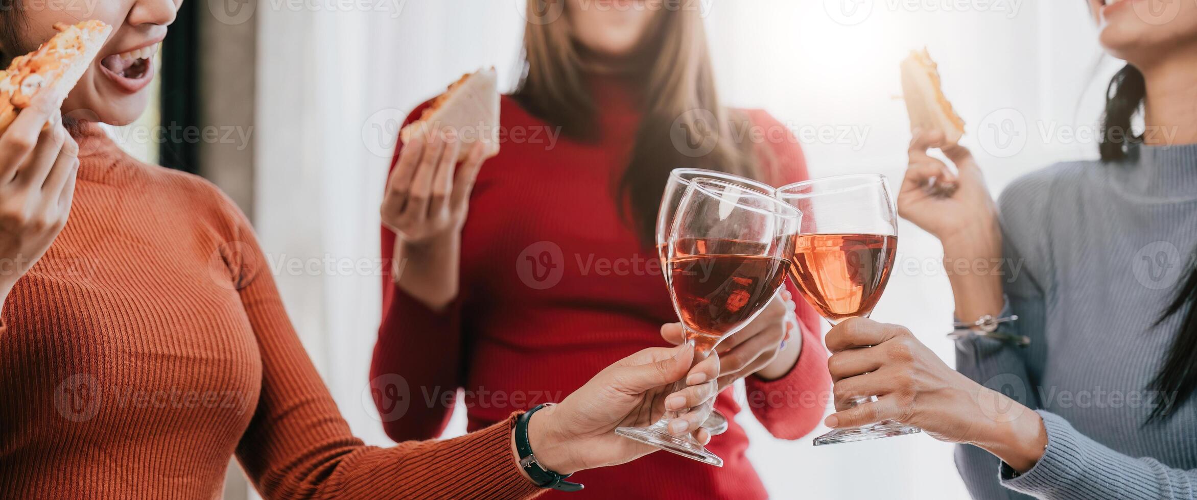 Group of Asian friends gather to celebrate Christmas with champagne and eating pizza at home. Joy of holiday party with friends or colleague concept photo