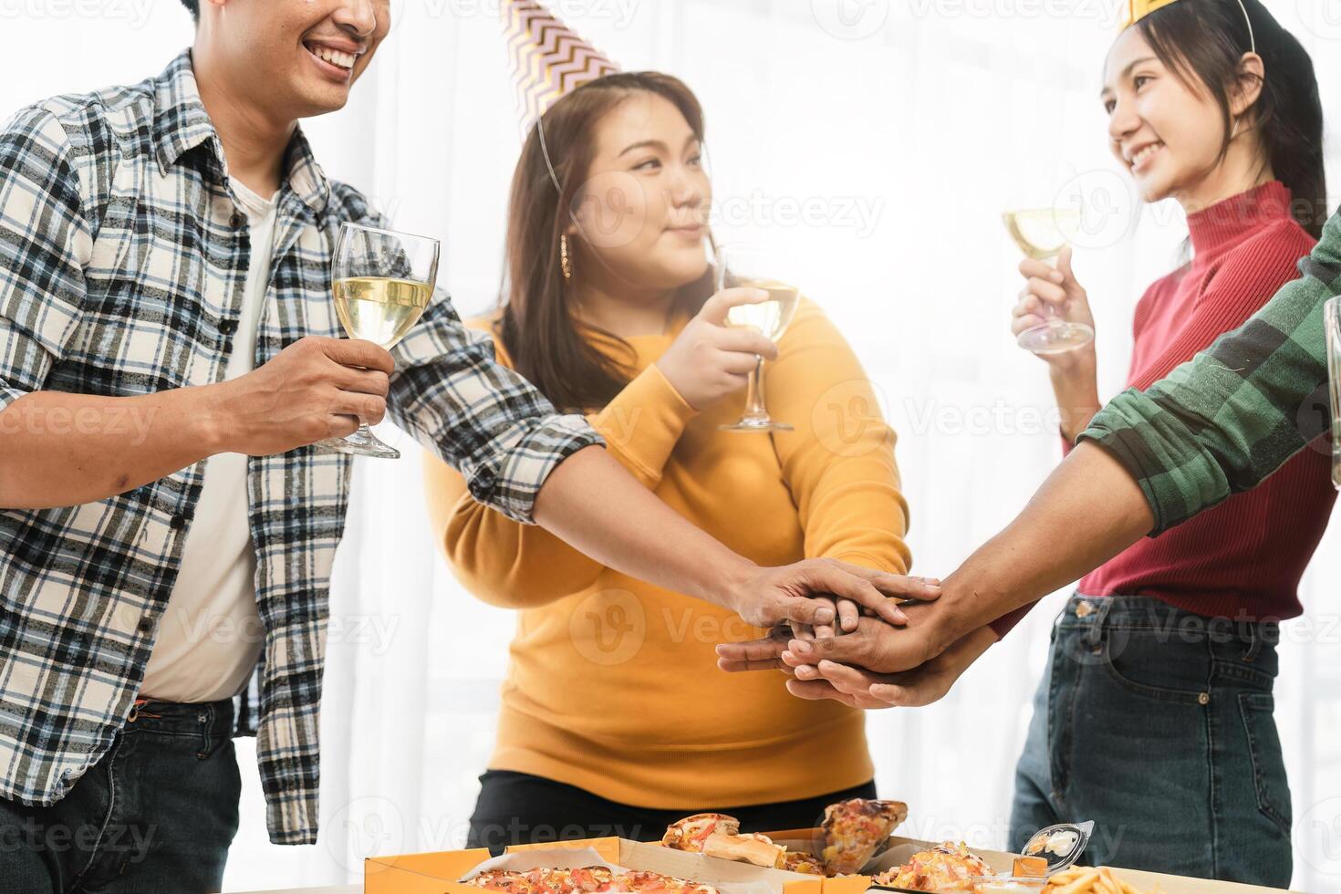 Group of happy colleagues having fun at a new year celebration or business success. Coworkers with diverse people at the office party photo