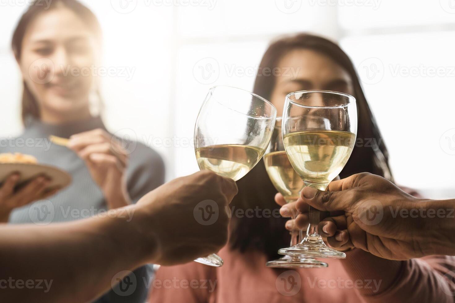 Group of happy colleagues having fun at a new year celebration or business success. Coworkers with diverse people at the office party photo