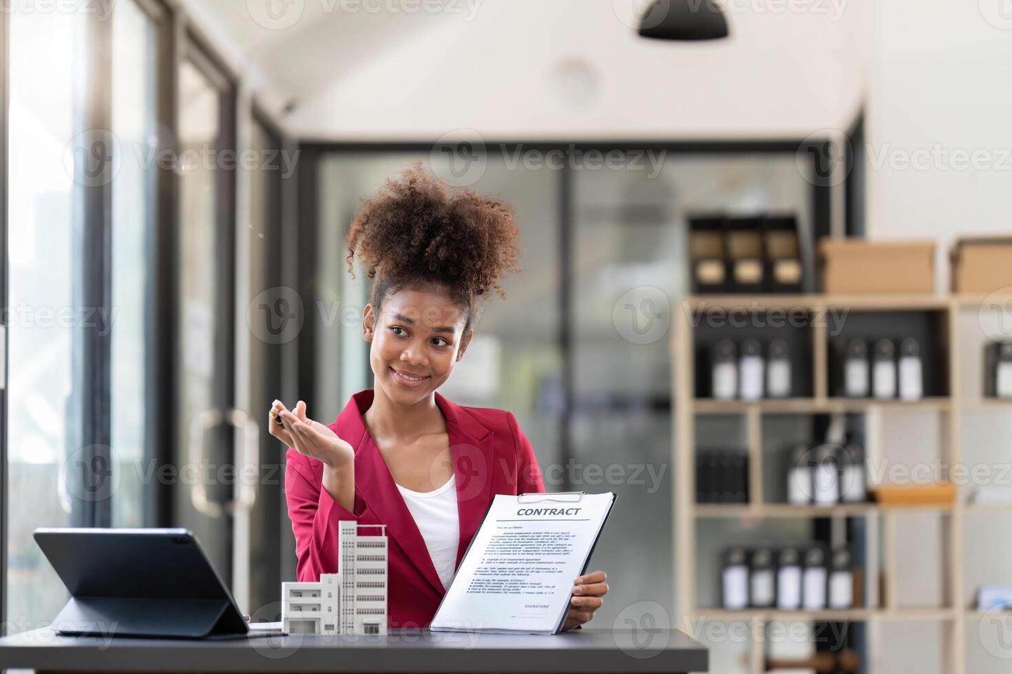 Contacting the buying or selling of real estate through a sales representative offering a contract to buy a house or apartment, condo and providing house keys for success photo