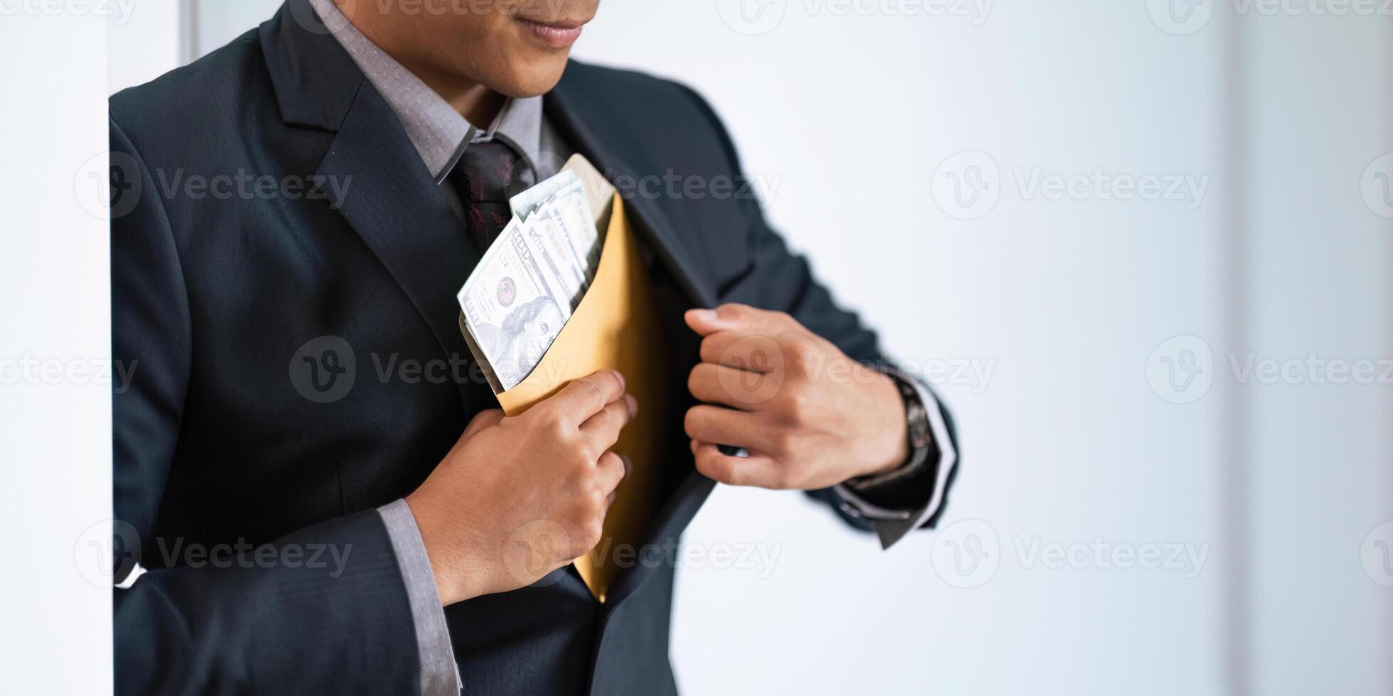 Businessman briefcase document envelope with dollar banknotes on white background. businessman putting illegal secret agreement money in his jacket. corruption, bribery, crime and embezzle concept photo