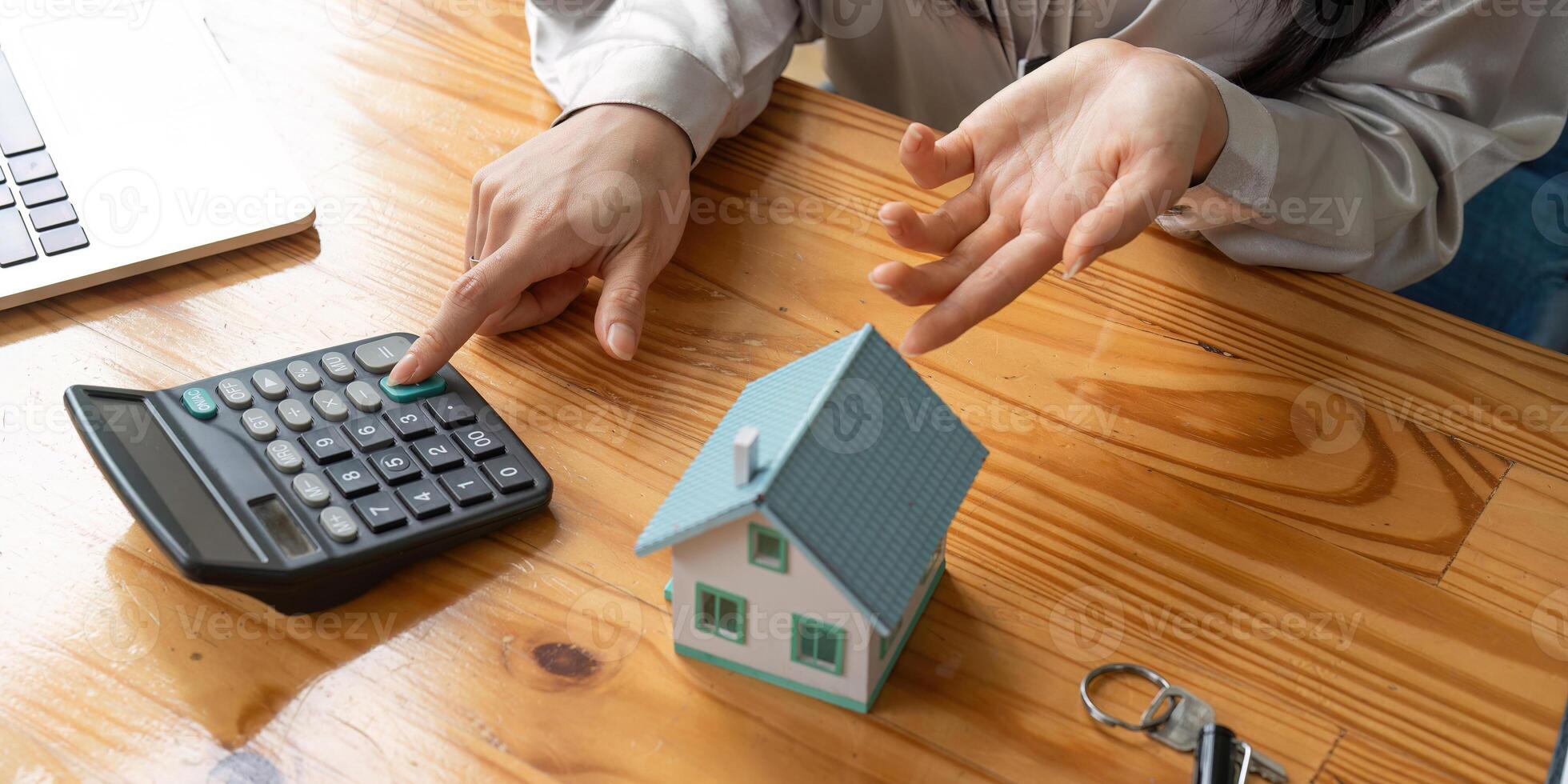 Real estate agent or bank officer describes the loan or mortgage interest to the customer with home purchase contract or on office loan and interest rate photo