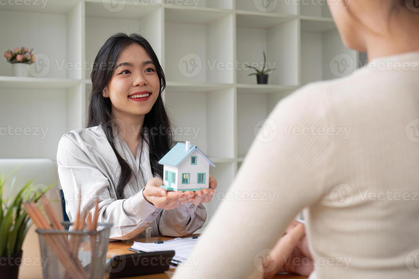 Real estate agent and client explain mortgage loan contract. Make a contract for hire purchase and sale of a house. home mortgage loan insurance concept. photo