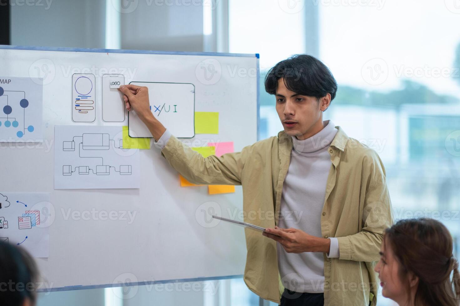 Ux developer and ui designer use augmented reality brainstorming about mobile app interface wireframe design on desk at modern office. creative digital development agency photo