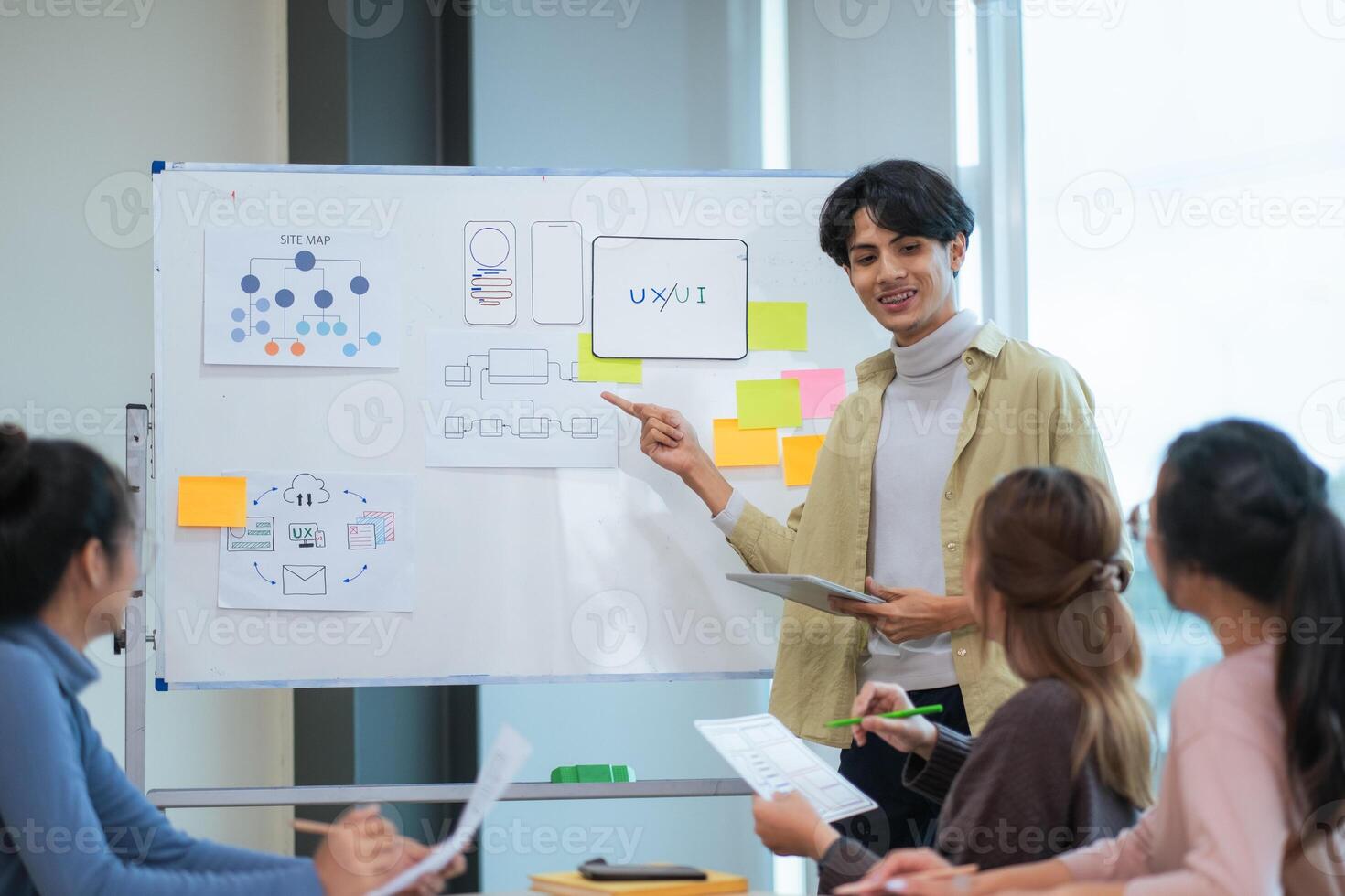 Ux developer and ui designer use augmented reality brainstorming about mobile app interface wireframe design on desk at modern office. creative digital development agency photo