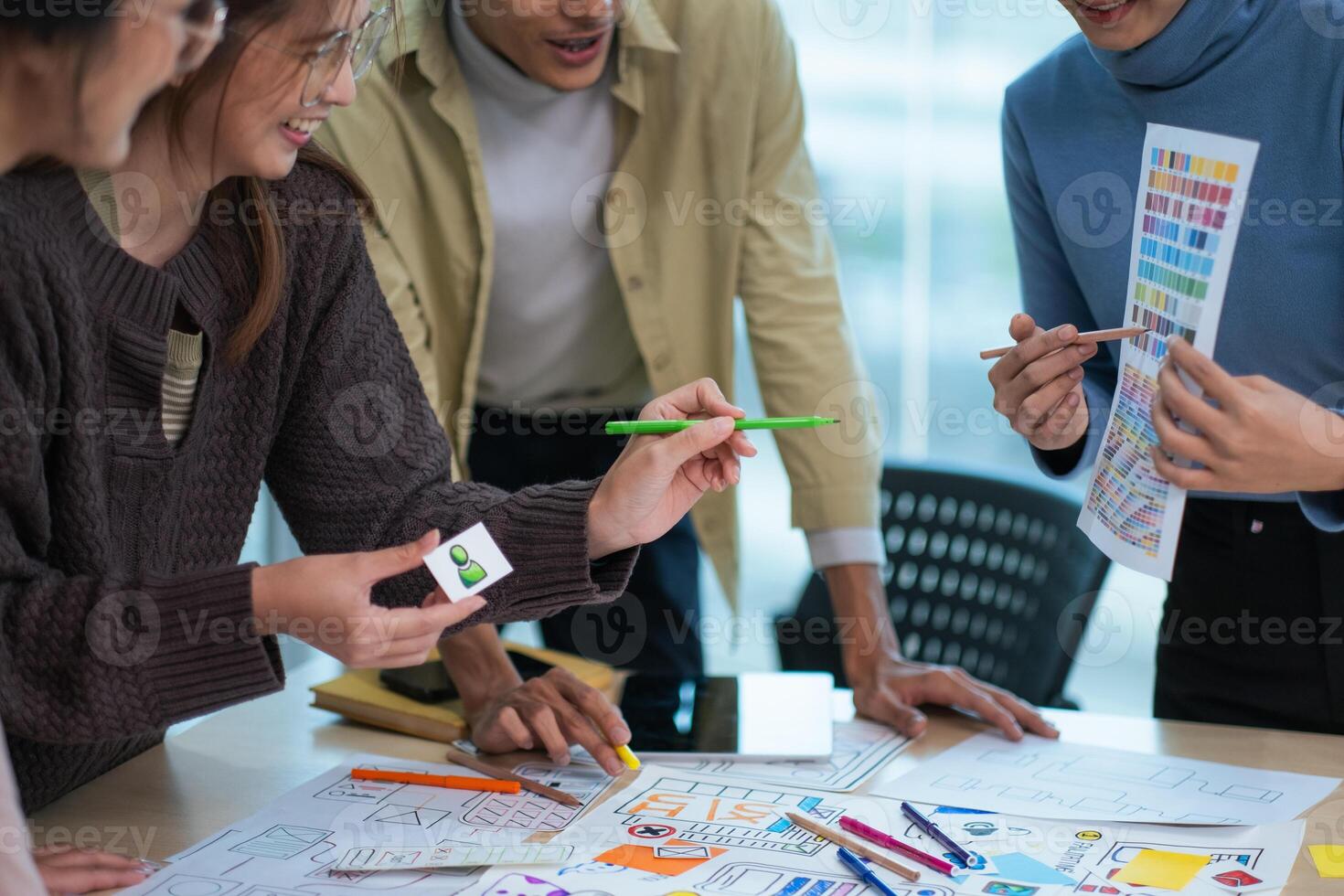 creative digital development agency brainstorming about mobile app interface wireframe design on desk at modern office photo