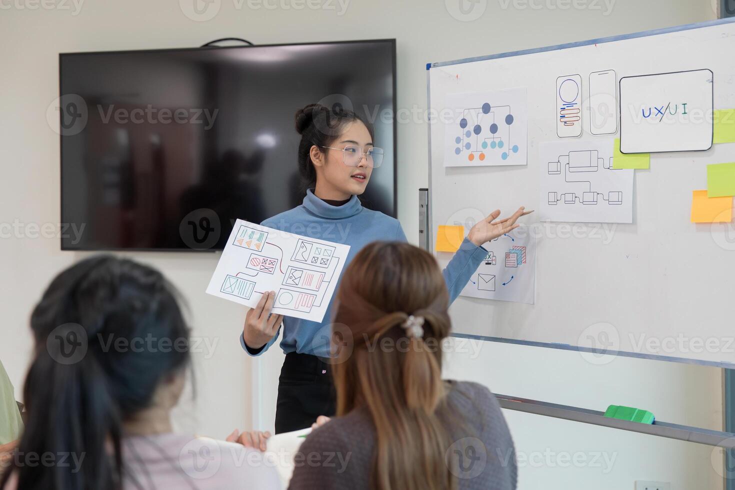ux developer and ui designer presenting and testing mobile app interface design on whiteboard in meeting at modern office. Creative digital development mobile app photo