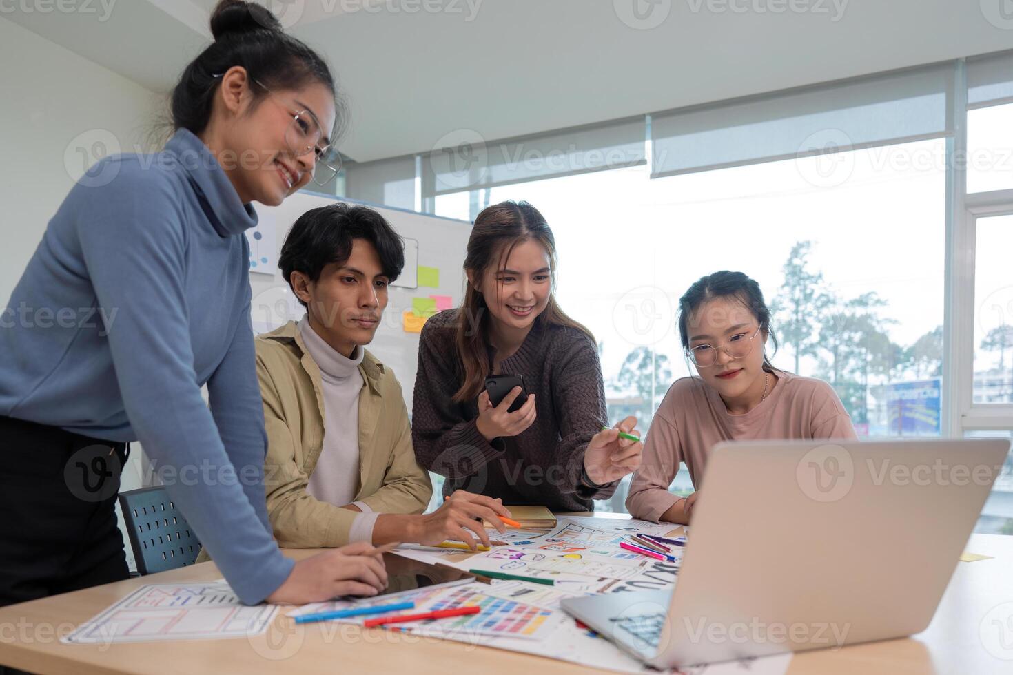 UX developer and ui designer brainstorming about mobile app interface wireframe design at modern office photo