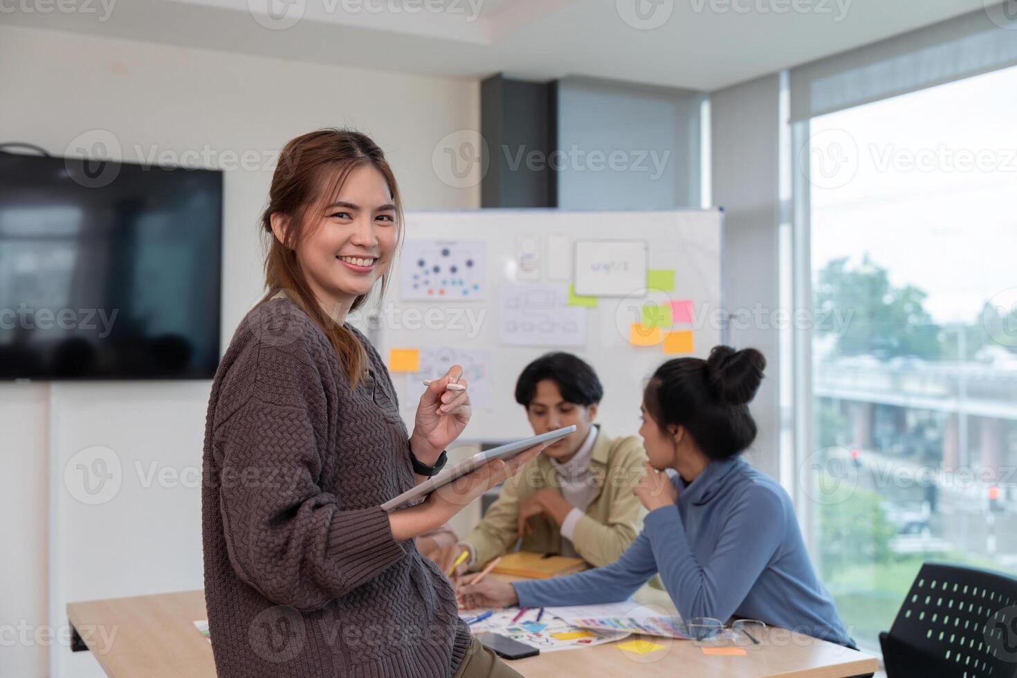 Designer woman with tablet planning application for mobile phone. UX UI designer concept photo