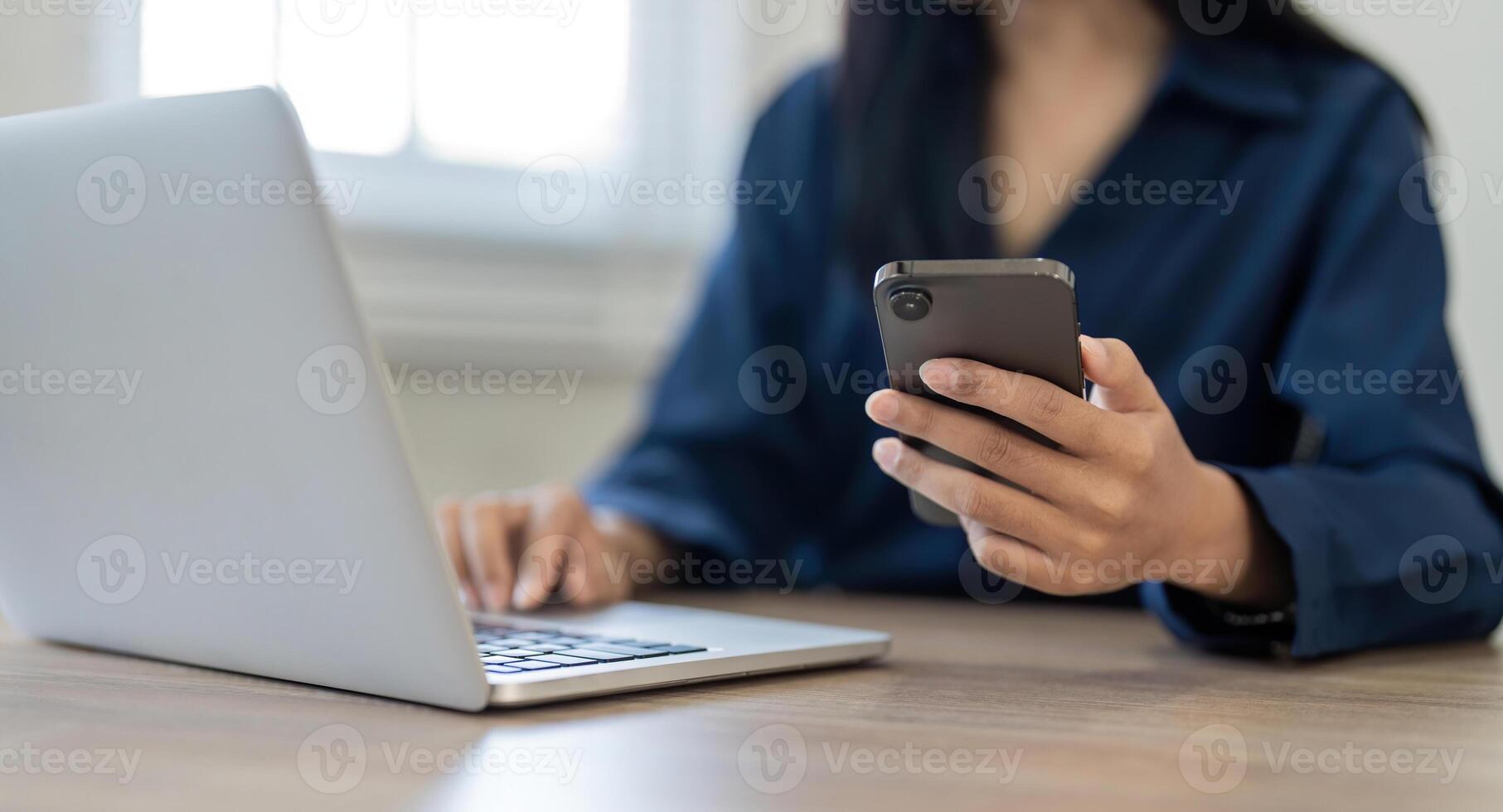 Woman search information from the internet network. Business woman working with smartphone and laptop computer on table in home. network concept photo