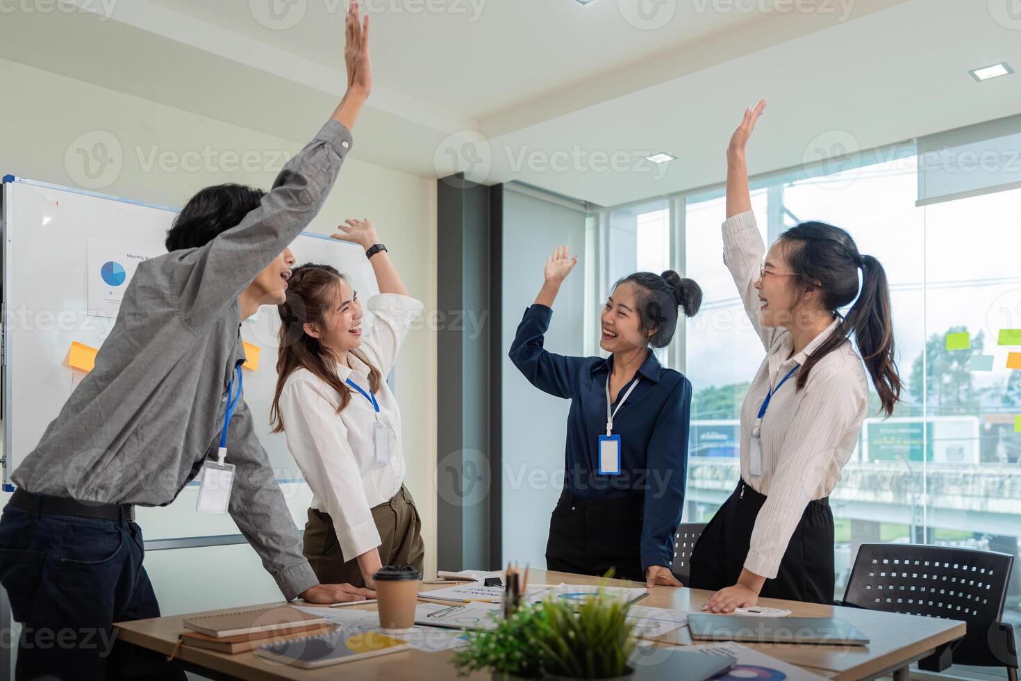 Business team celebrate corporate victory together in office, laughing and rejoicing, smiling excited employees colleague screaming with joy in office photo