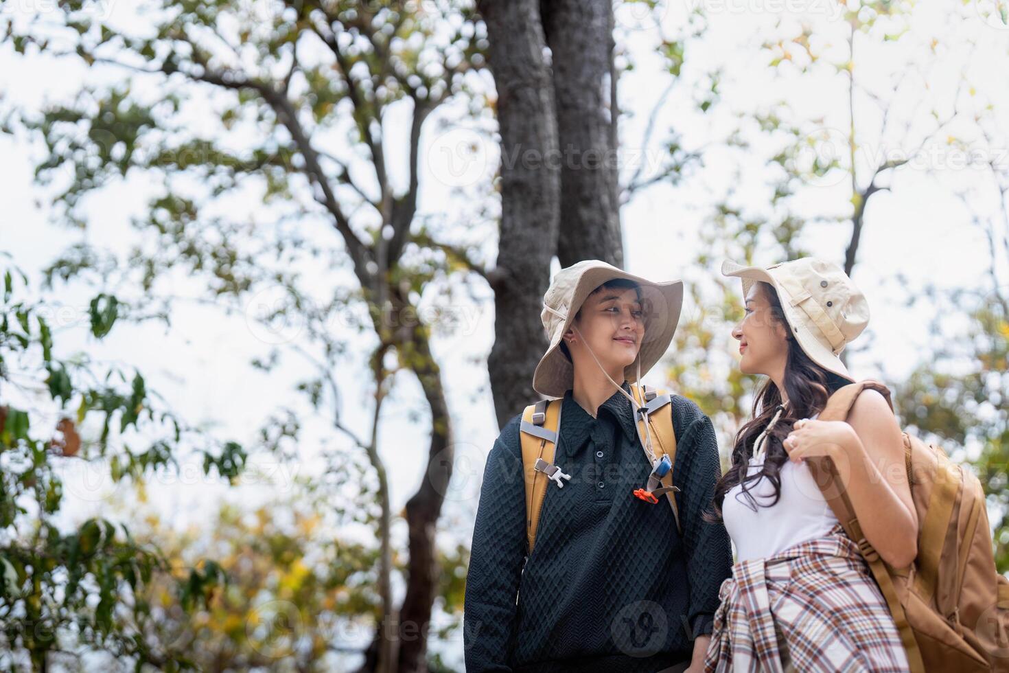 Lovely couple lesbian woman with backpack hiking in nature. Loving LGBT romantic moment in mountains photo