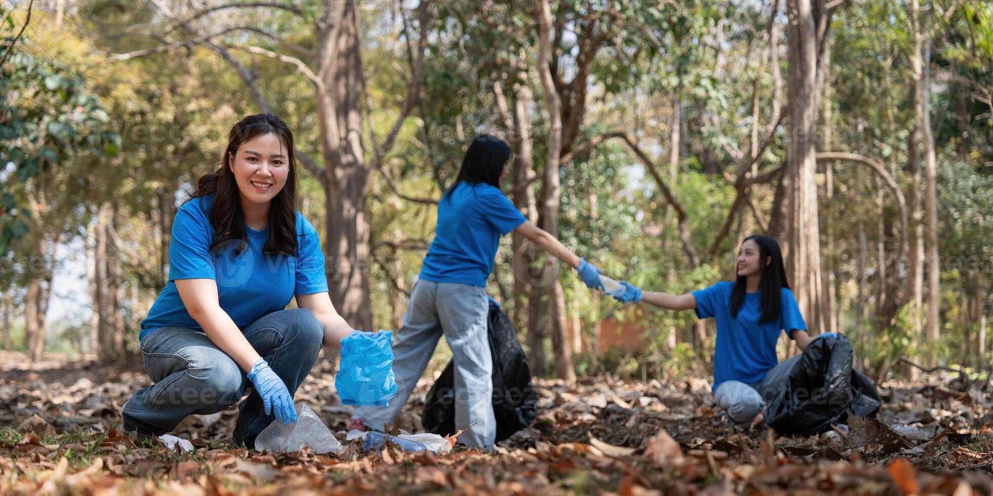 Volunteer collecting plastic trash in the forest. The concept of environmental conservation. Global environmental pollution. Cleaning the forest photo