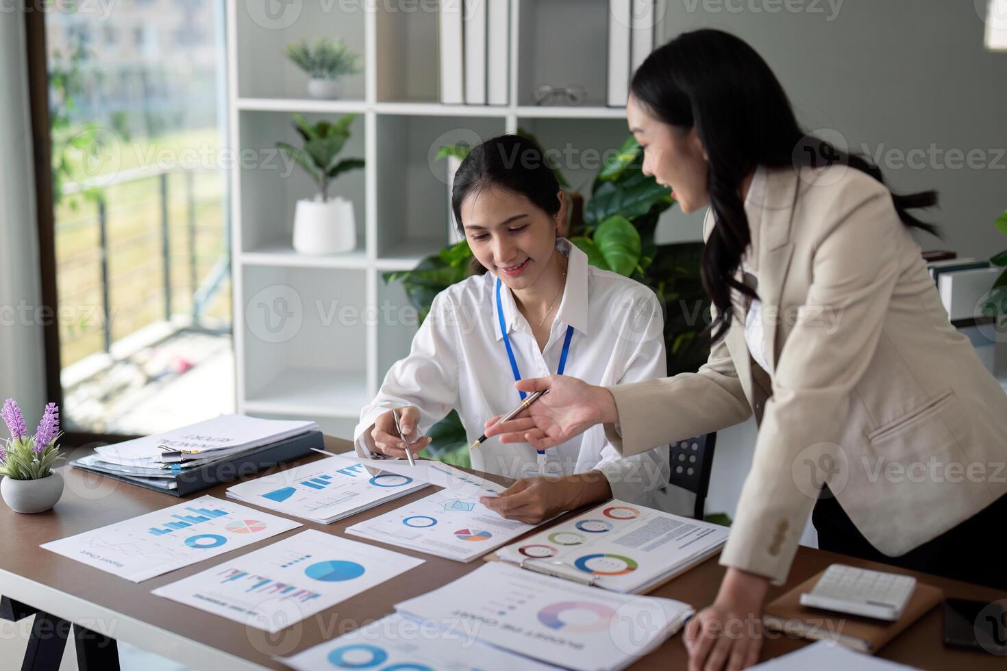 Businesswomen discussing charts and graphs in office. Concept of teamwork and data analysis photo