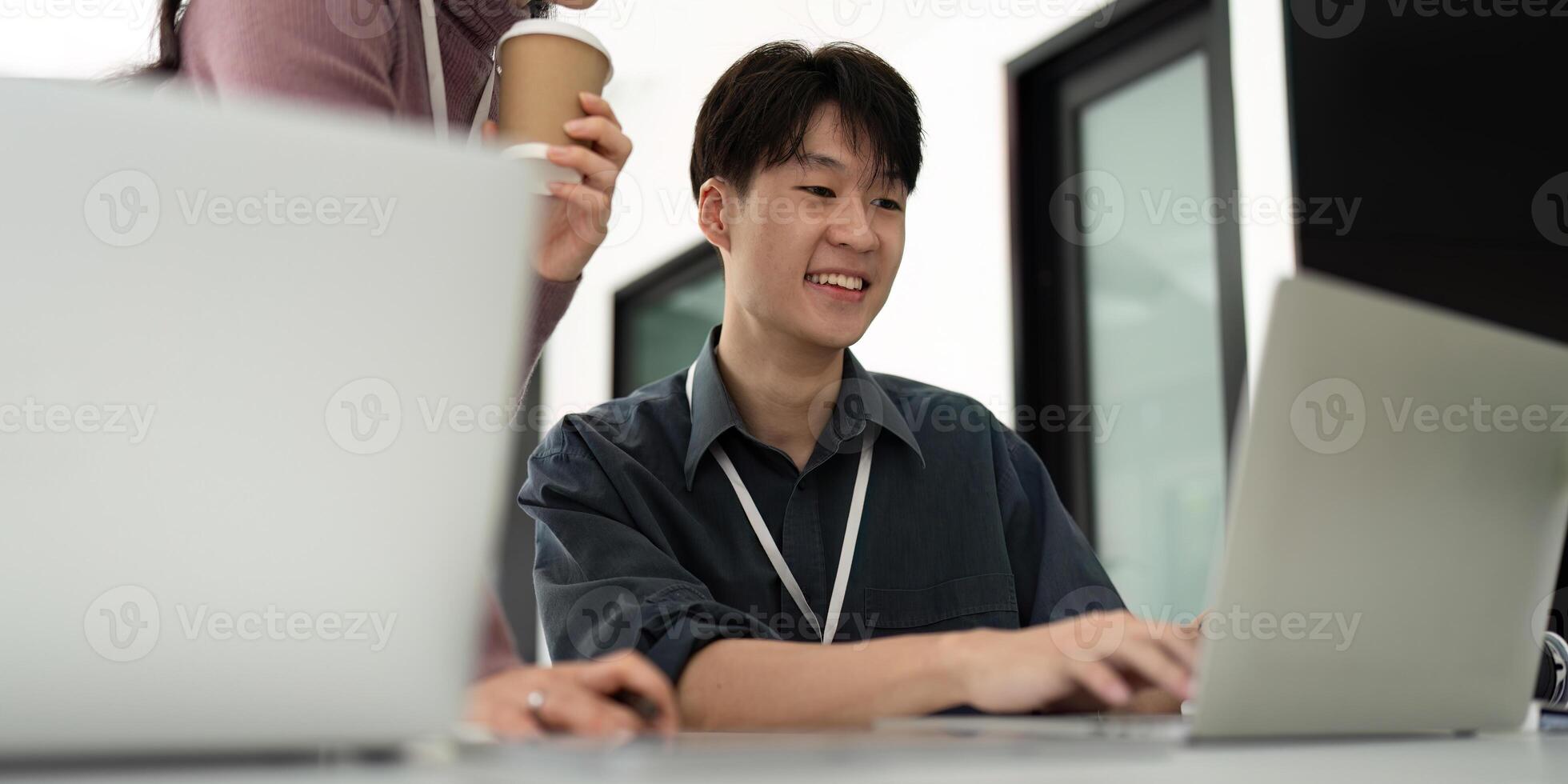Asian Business Colleagues Working on Laptop. Concept of Teamwork and Collaboration photo