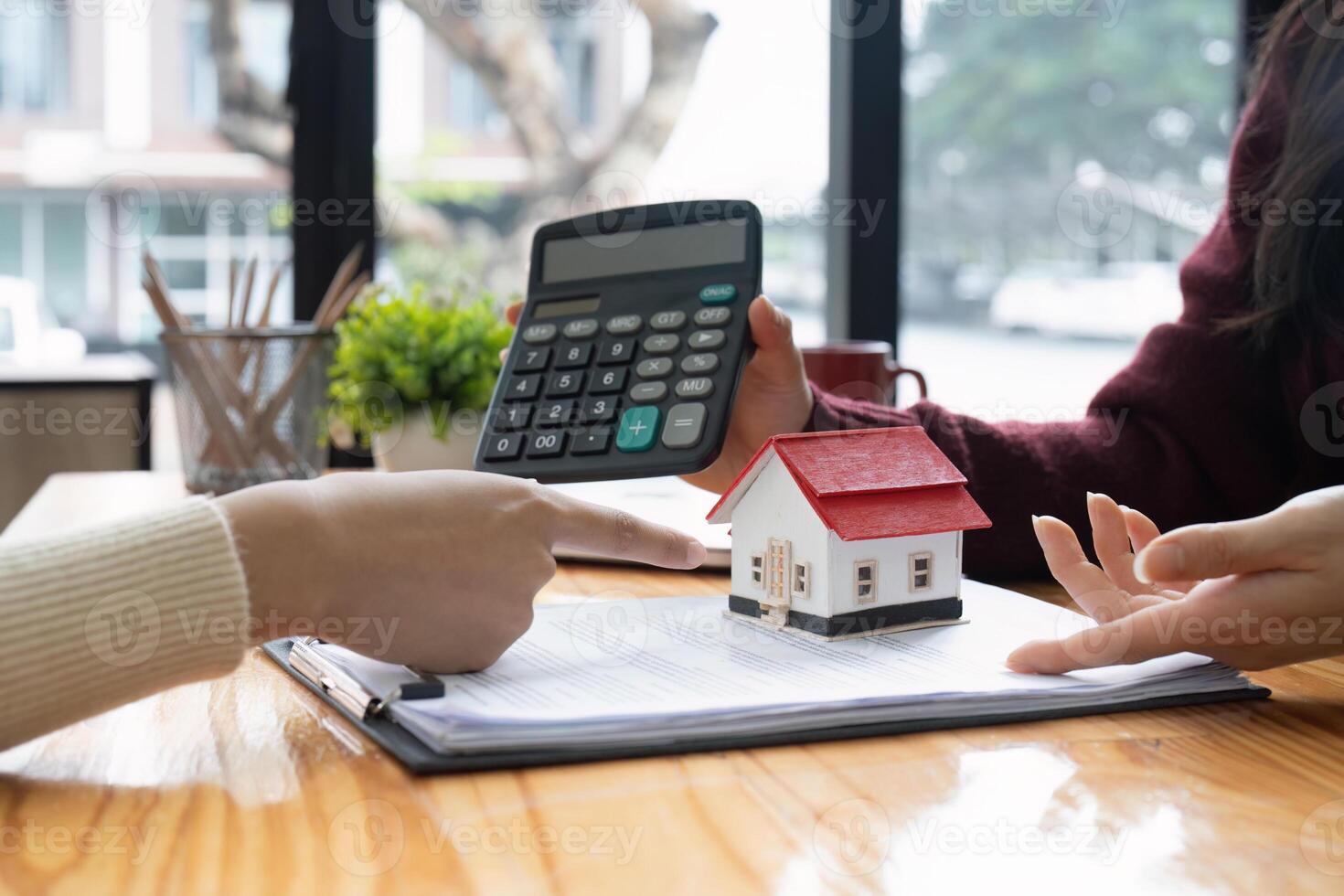 Real estate agent showing home loan interest to client. Concept of financial consultation and mortgage photo