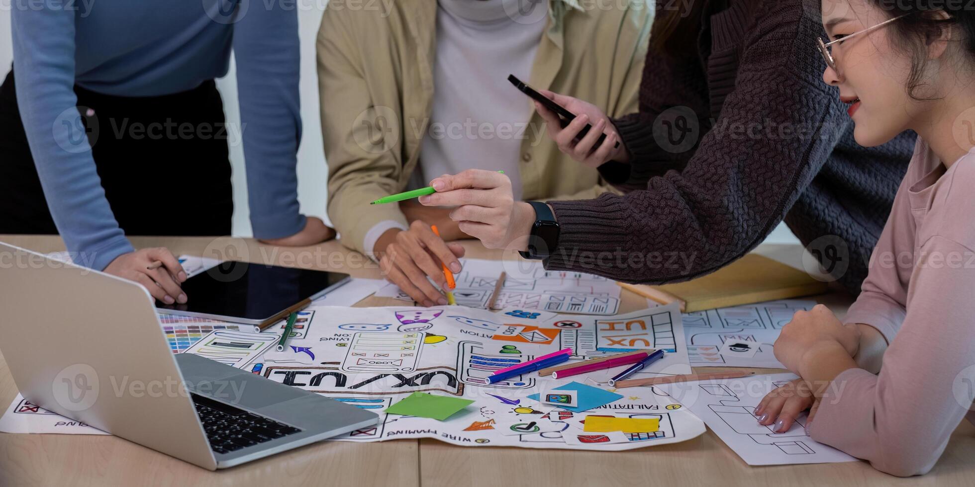 Creative UX Developer and UI Designer Team Brainstorming Session with Digital Devices and Design Sketches for Innovative User Experience Solutions photo