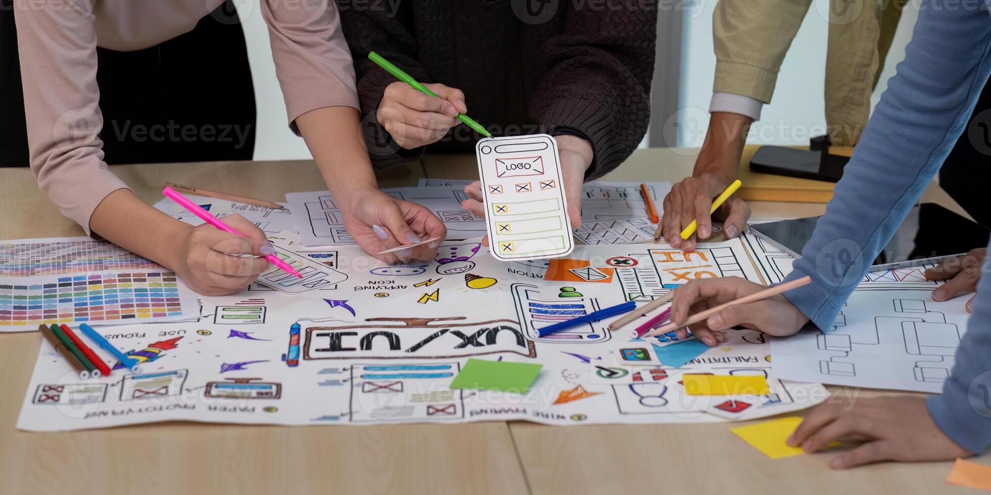 collaboration UX Developer and UI Designer Brainstorming Session with Creative Sketches and Prototypes on a Table photo