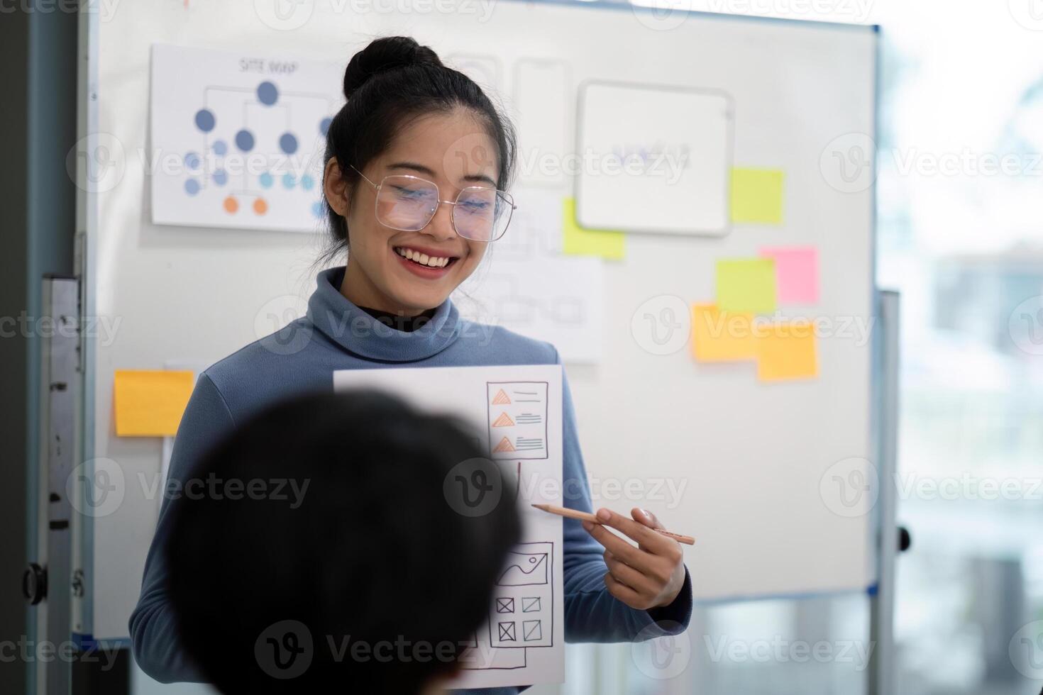 Creative UX Developer and UI Designer Brainstorming Session with Wireframes and Flowcharts on Whiteboard in Modern Office photo