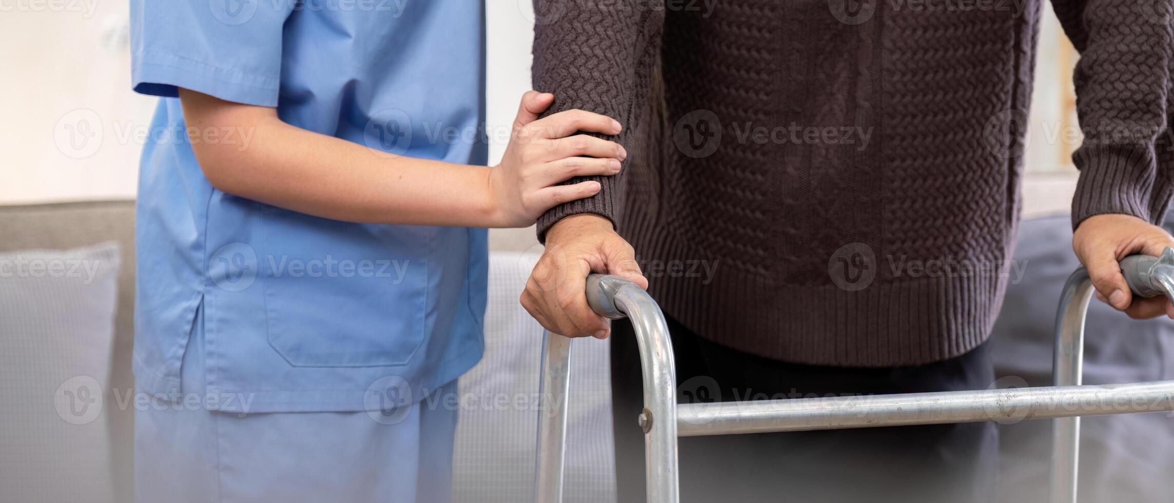 Caregiver Assisting Elderly Patient with Physical Therapy Using Walker in Home Setting for Rehabilitation and Mobility Support photo