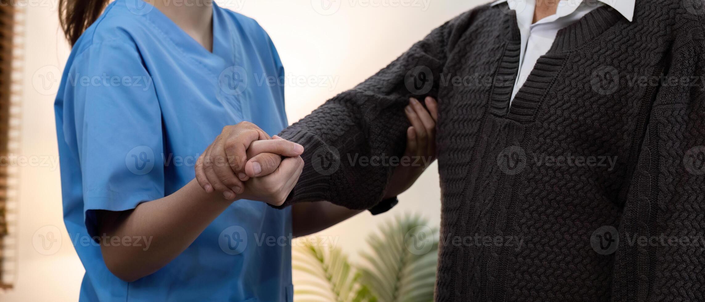 Caregiver Assisting Elderly Patient with Physical Therapy Exercise at Home for Improved Mobility and Health photo
