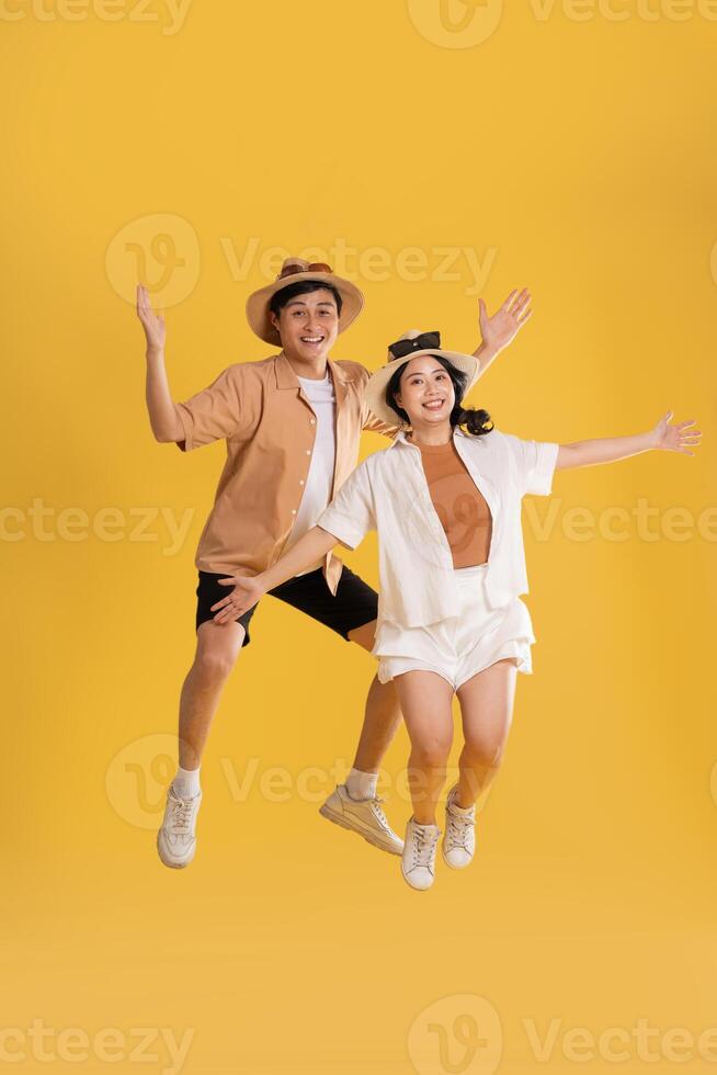 Portrait image of couple posing on yellow background, summer, travel photo