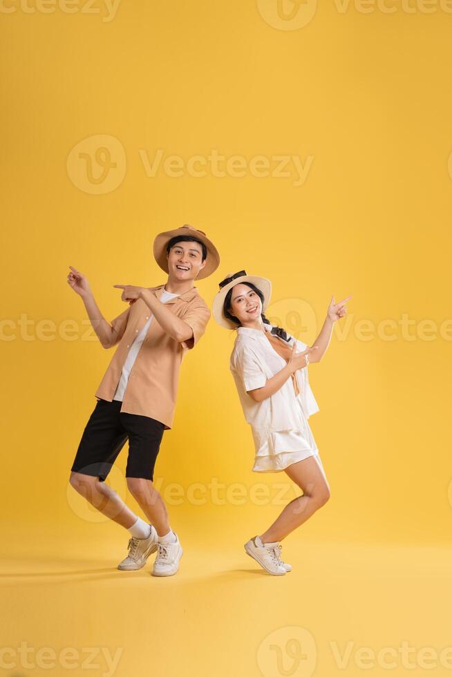 Portrait image of couple posing on yellow background, summer, travel photo
