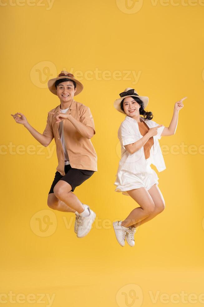 Portrait image of couple posing on yellow background, summer, travel photo