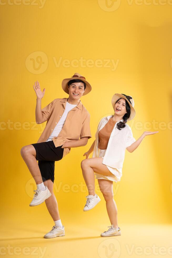 Portrait image of couple posing on yellow background, summer, travel photo