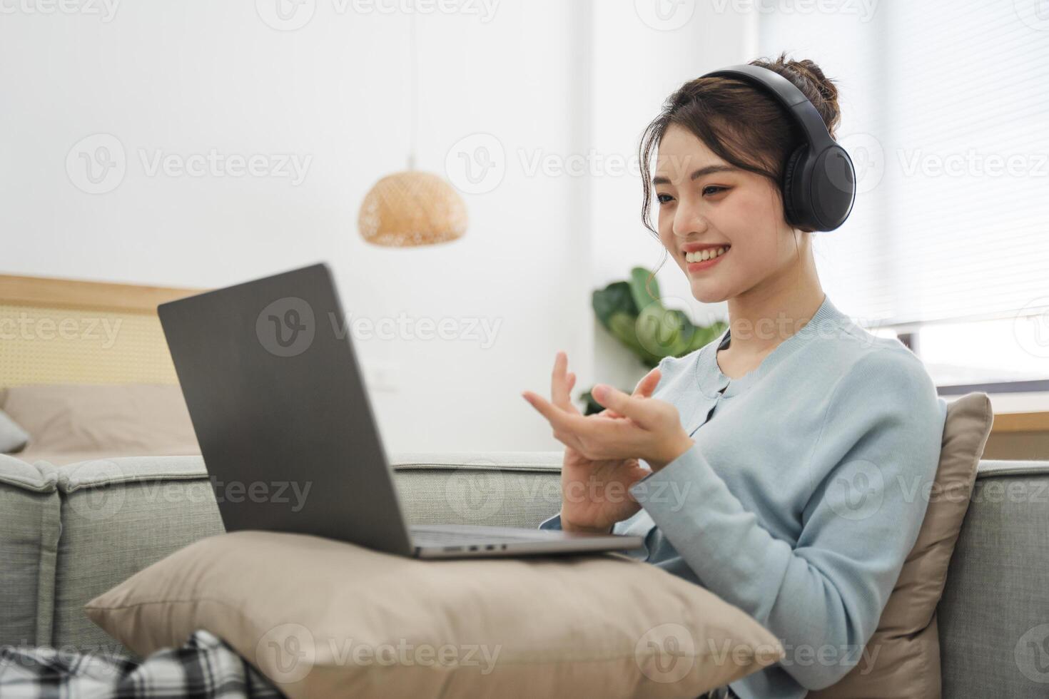 Portrait of Asian woman sitting on sofa at home photo